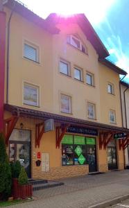 a store front of a building on a street at Apartamenty Bełska Centrum in Ustrzyki Dolne