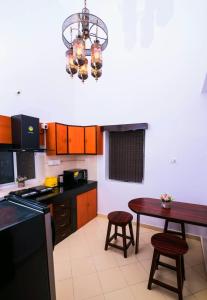 a kitchen with a table and a chandelier at 'Golden Sand Dunes' 1bhk Benaulim beach apartment in Madgaon