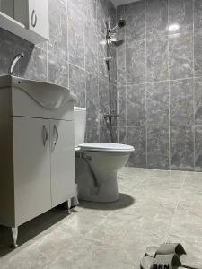 a bathroom with a toilet and a sink and a shower at İnkaya hotels in Yıldırım