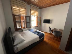 a bedroom with a bed and a desk and a window at İnkaya hotel in Yıldırım