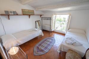 a room with two beds and a window at Villa Crisci Appartamenti Selene e Sirio in Vasto