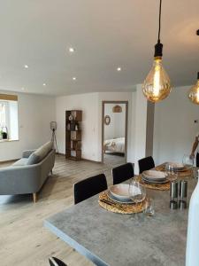 sala de estar con mesa y sofá en Superbe appartement neuf et cosy 77 m2 en Villers-le-Lac