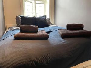 a bed with two pillows on top of it at 4 bedroom flat in the heart of Oslo in Oslo
