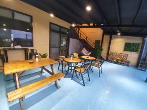 a patio with tables and chairs in a building at Stay if you wish Homestay in Jiufen