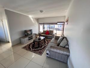 a living room with a couch and a table at Safi Luxury Apartment 7 in East London