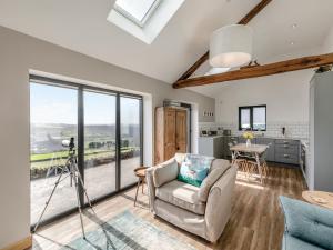 a living room with a view of the kitchen and dining room at Shutlingsloe in Mellor