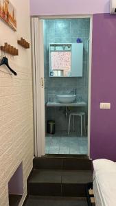 a small bathroom with a sink and a tub at Violet 27 in Florence