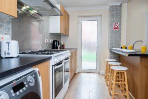 uma cozinha com um fogão e uma máquina de lavar louça em Shirley House 4, Guest House, Self Catering, Self Check in with smart locks, use of Fully Equipped Kitchen, close to City Centre, Ideal for Longer Stays, Excellent Transport Links em Southampton