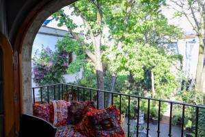 a room with a balcony with pillows on it at Gallery and Boutique BNB in San Angel Inn in Mexico City