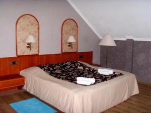 a bedroom with a large bed with two mirrors at Hotel NADIKVARI in Tbilisi City