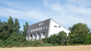 a building on the side of a field at Haus Dortmund FeWo 1 in Cuxhaven