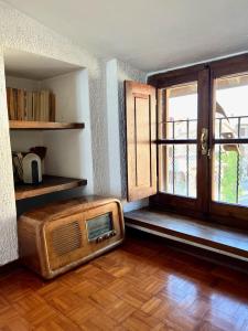 a room with an old radio sitting on a wooden floor at La Casa del Castello in Montemerano