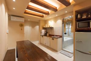 a kitchen with a wooden table in a room at Jeonju Hanok Little Prince in Jeonju