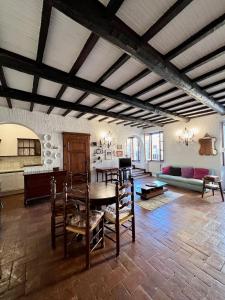 a large living room with a table and chairs at La Casa del Castello in Montemerano