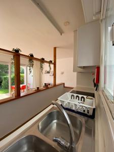 a kitchen with a sink and a counter top at Coves Noves Nice apartment of 75 m2 10 minutes walk from the beach of Arenal d'en Castell in Es Mercadal