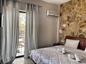 a bedroom with a bed with towels on it at Hotel Kastri in Loutra Edipsou