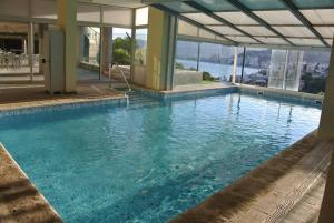 a large swimming pool with a view of the water at Racó de la Mar in Faro de Cullera