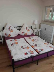 a bed with two sheets and pillows on it at Urlaub in der königlichen Villa in Berchtesgaden