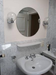 y baño con lavabo blanco y espejo. en Urlaub in der königlichen Villa, en Berchtesgaden