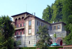 a large building on top of a hill with trees at Urlaub in der königlichen Villa in Berchtesgaden