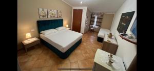 a bedroom with a large bed in a room at La Rosa Blu in San Vito lo Capo