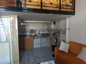 a living room with a couch and a kitchen at Al fouad in Abu Simbel