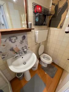 a bathroom with a sink and a toilet at Casa vacanze Nido al Mare in Sanremo