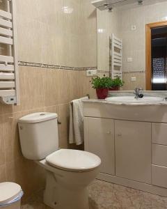 a bathroom with a toilet and a sink at MANDARINA in Riumar +2 photos