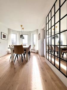 a living room with a table and chairs and a dining room at Luxus Ferienhaus Erzgebirge in Alleinlage in Kurort Altenberg