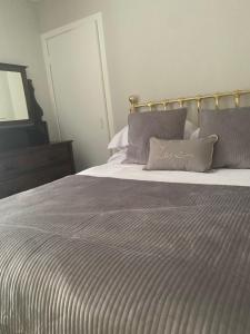 a bedroom with a large bed with a striped blanket at The Crescent in Dundee