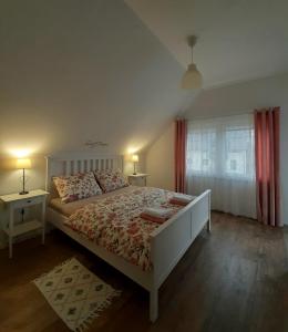 a bedroom with a bed and a window with red curtains at Elegant Inn Gospić in Gospić