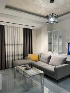 a living room with a couch and a table at Apartment Aulona Park in Vlorë