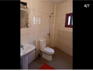a bathroom with a toilet and a sink at Free Studio in Dakar