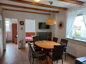 a dining room with a table and chairs at Sosnowka in Pobierowo