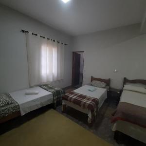 Un pat sau paturi într-o cameră la Casa para Aluguel de Temporada - Carrancas MG