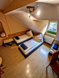 a bedroom with two beds in a attic at Hotel am Rathaus in Kassel