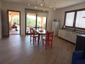 a kitchen and dining room with a table and chairs at La Residenza di Campagna in Manciano +21 photos