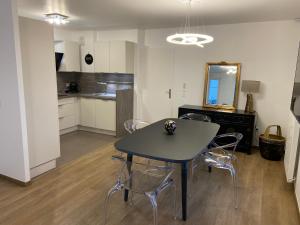 a dining room table and chairs in a room at Disneyland comfort & magic- 15 minutes walk from Disneyland Paris in Serris