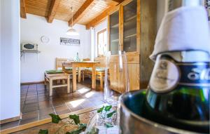 a kitchen and dining room with a bottle of wine at Cozy Home In Regen With Wifi in Regen