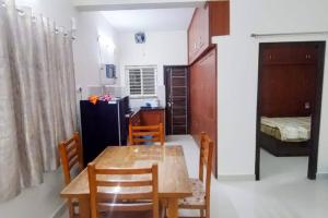 a kitchen and dining room with a table and chairs at 2 Bhk Fully Furnished Hafeezpet #101 in Hyderabad