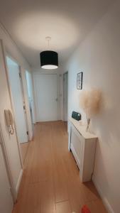 a room with a hallway with white walls and wooden floors at Waterfront town centre ipswich apartment in Ipswich