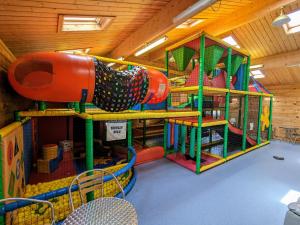 a play room with a play system in a building at 35 Gower Holiday Village in Reynoldston
