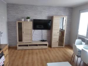 a living room with a tv and a entertainment center at Poziom 7 in Elblag
