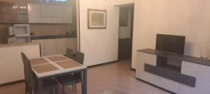 a kitchen with a small table and a television at CASA DELLA NONNA in Bagnolo Mella