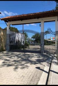 a gate to a building with a pavilion at Penedo Flats in Penedo