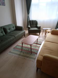 a living room with two couches and a coffee table at daily rental apartment 5 minutes to the airport in Pazar