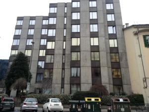 a tall building with cars parked in front of it at MARCONI TURIN Loft, studio nei pressi di Porta Nuova in Turin