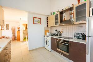 a kitchen with a stove and a dishwasher at Skiathos Seaview Villa with Pool in Punta