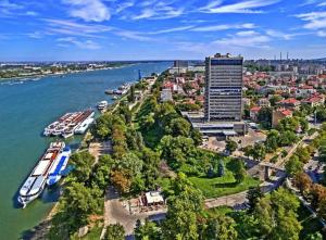 an aerial view of a river with boats docked at Marvelous Riverside Flat in Ruse