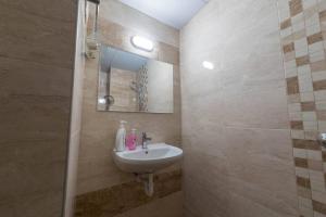 a bathroom with a sink and a mirror at Marvelous Riverside Flat in Ruse +22 photos